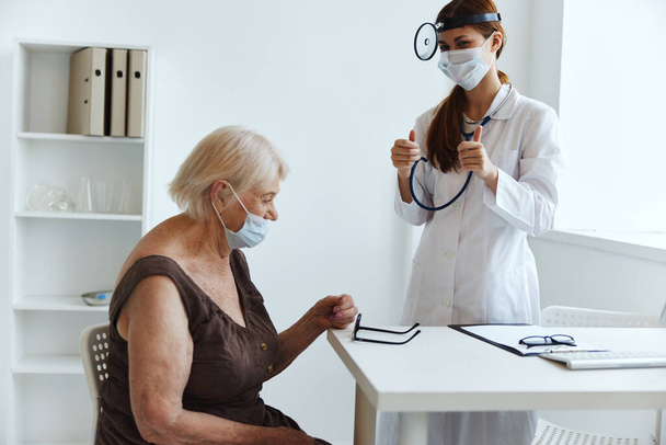 old woman patient at the doctor stethoscope - Photo, Image