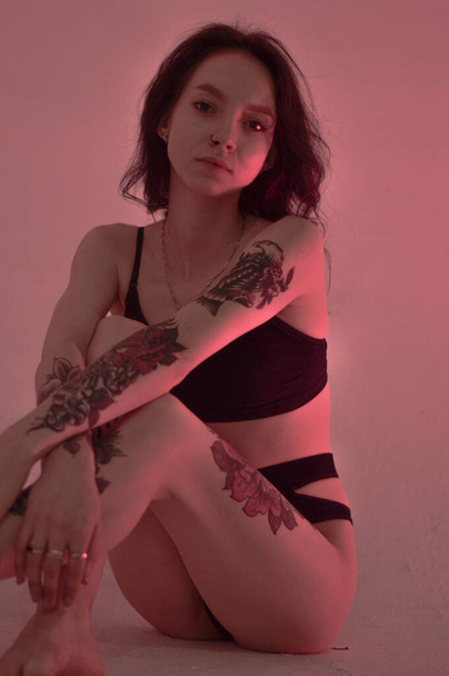 erotic girl in lingerie sits on the floor and in pink - Fotó, kép