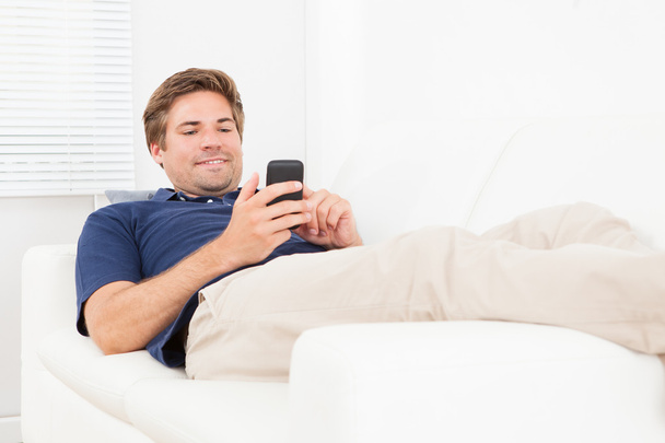 Relaxed Man Messaging On Smart Phone - Photo, Image