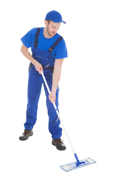 Male servant mopping floor - Фото, зображення
