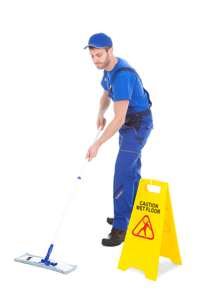 Male servant mopping floor - Photo, Image