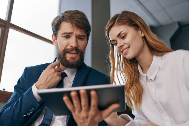 man and woman in business suits work with a tablet technology office - Foto, immagini
