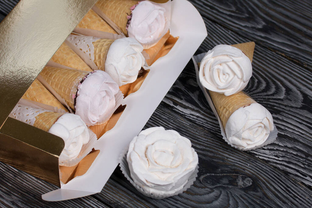 Homemade marshmallows in a craft box. Marshmallow in a waffle cone. Made in the shape of a rose. Close-up shot. - Photo, image