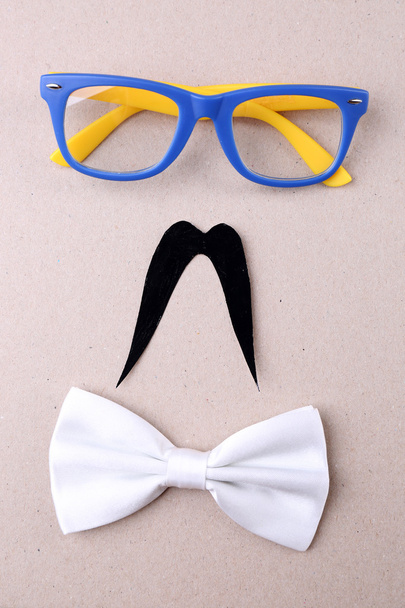 Glasses, mustache and bow tie forming man face - Foto, afbeelding