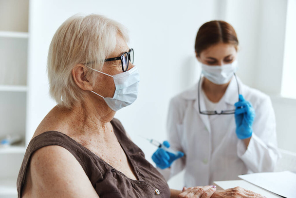 elderly woman wearing a medical mask immunization safety health care - Photo, image