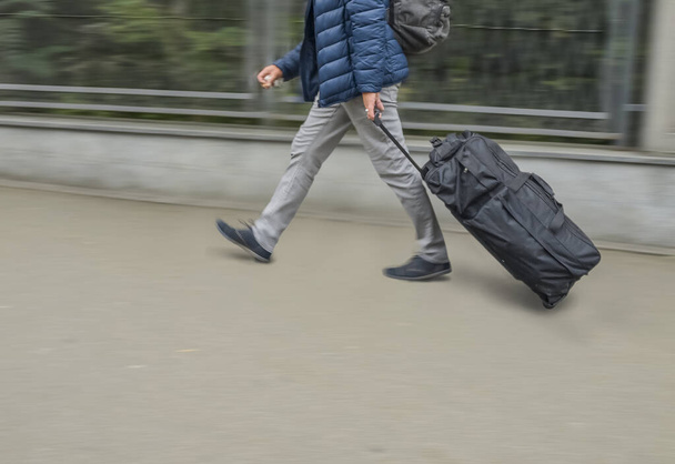 Man walking with suitcase in modern open space  - Φωτογραφία, εικόνα