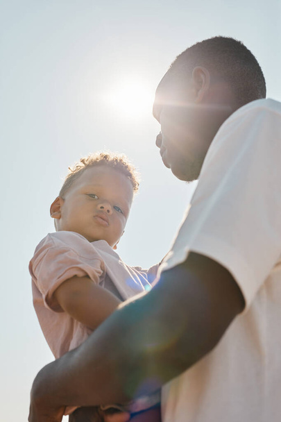 Father with Baby Son in Sunlight - Photo, Image