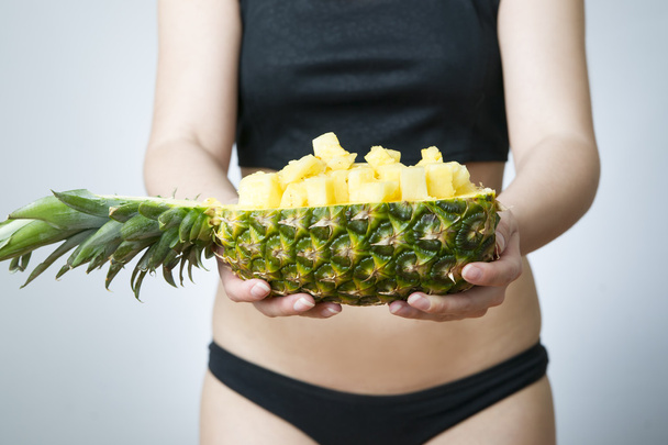 Young woman's body with pineapple - Valokuva, kuva