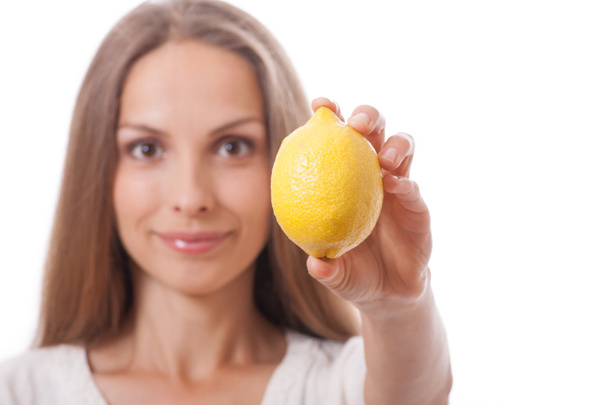 young woman holding a lemon - 写真・画像