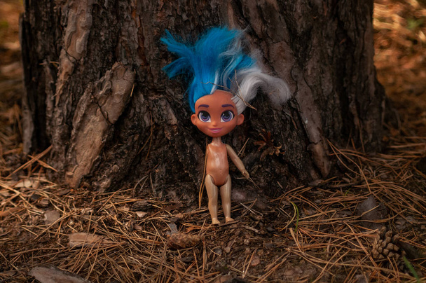 doll without a hand in front of a tree photo - Photo, Image