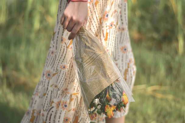 young woman in a dress with a bouquet of flowers - Photo, image