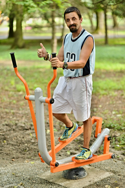 Man workout on a fitness machine - Photo, Image