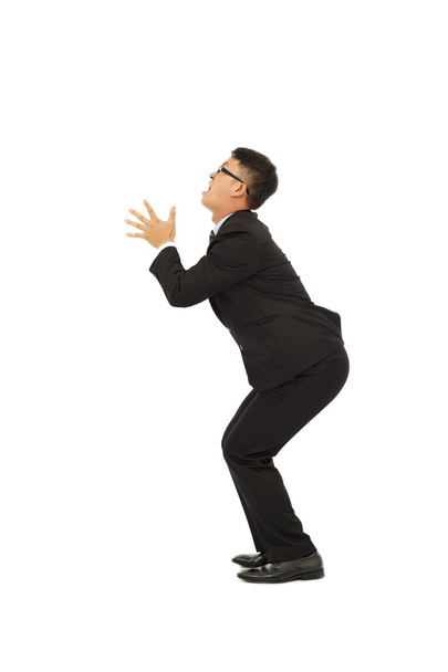 young business man standing a funny pose with white background - 写真・画像