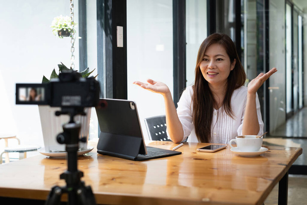 Business woman or blogger recording vlog on digital camera and live stream. - Foto, Bild
