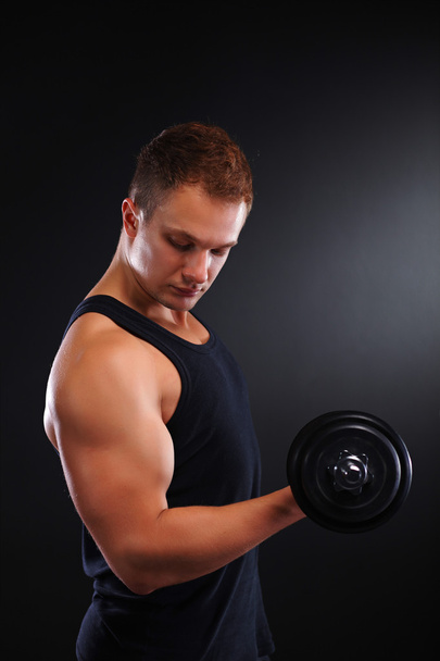 Fit muscular man exercising with dumbbell - Foto, Imagem