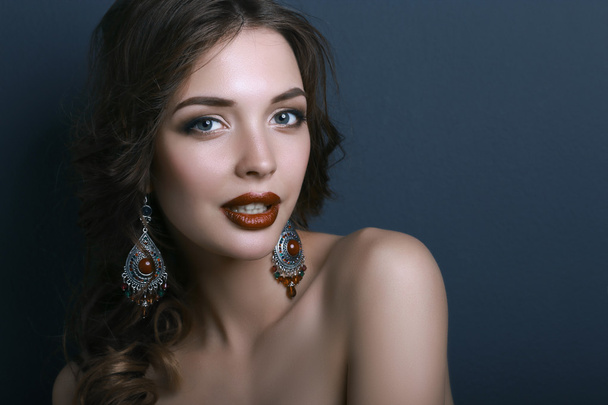 Portrait of young beautiful brunette woman in ear-rings - Zdjęcie, obraz