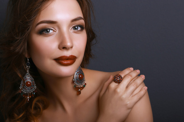 Portrait of young beautiful brunette woman in ear-rings - Foto, Imagem