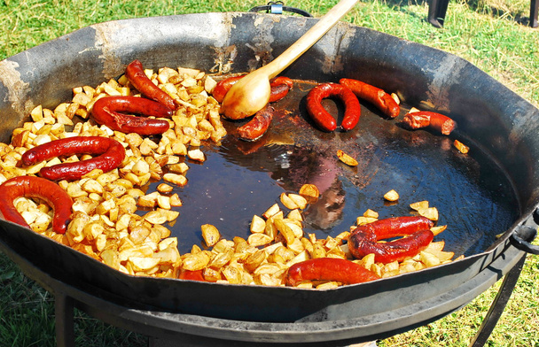 French fries and sausages in a pan - Photo, Image