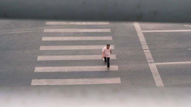 a young man is walking on the road - Фото, зображення