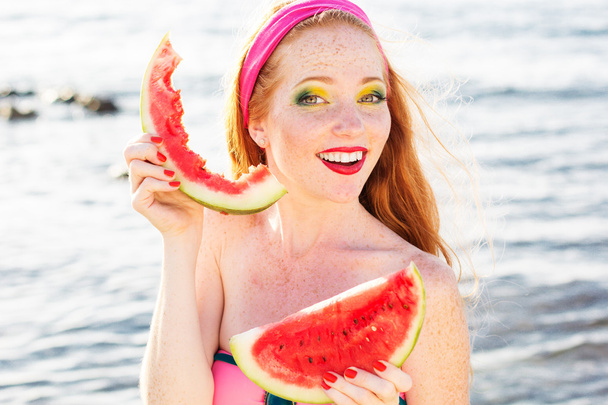 Smiling girl with freckles holding watermelon - Fotó, kép