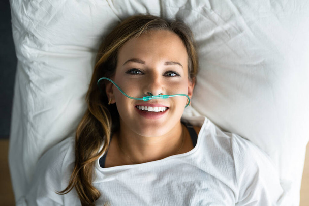 Sick Patient With Nasal Cannula. Ill Woman With Respiratory Disease - 写真・画像