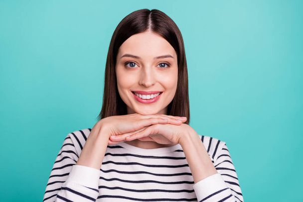 Photo of pretty positive lovely lady hands chin shiny smile wear striped shirt isolated on turquoise color background - Фото, зображення