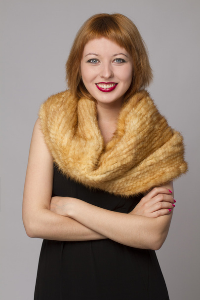 Smiling woman with a fur scarf - Foto, immagini