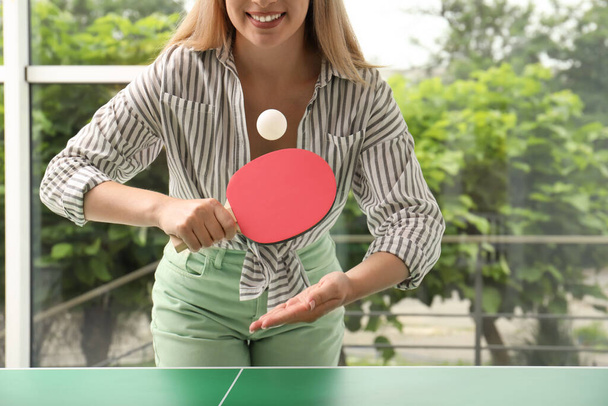 Woman playing ping pong indoors, closeup view - 写真・画像