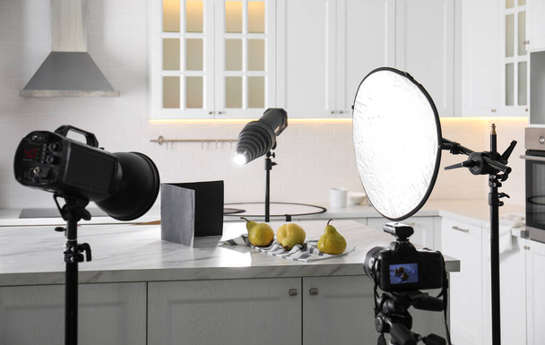 Professional equipment and many pears on table in kitchen. Food photo - Foto, Imagem