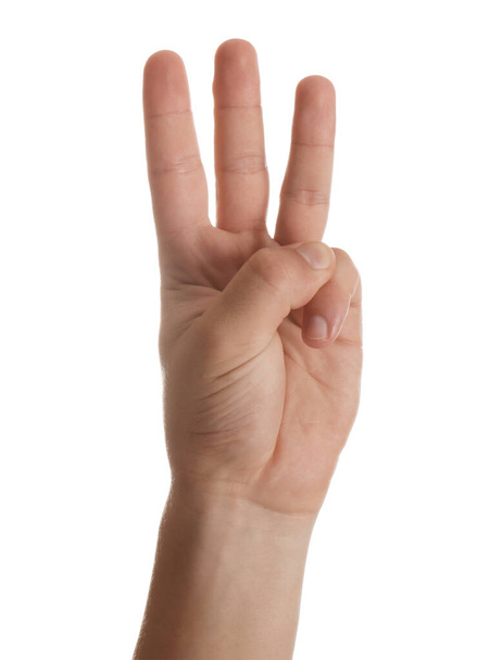 Teenage boy showing three fingers on white background, closeup - Photo, Image