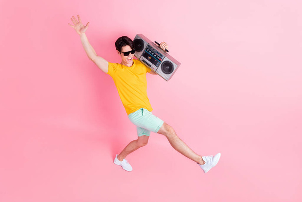 Top above high angle full body photo of young guy happy smile hold boom box go isolated over pink color background - Fotoğraf, Görsel