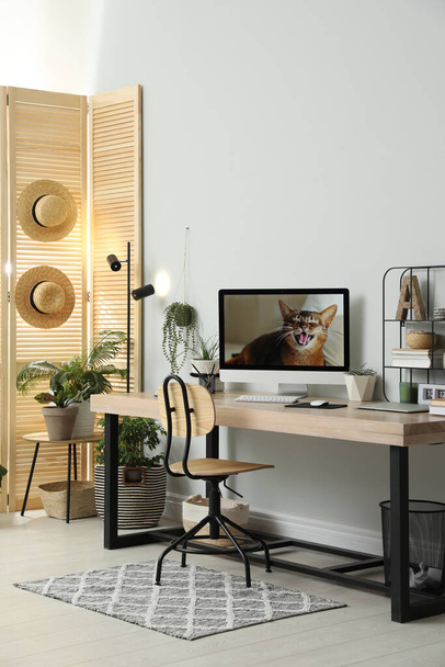 Comfortable workplace with computer in light room. Interior design - Photo, Image