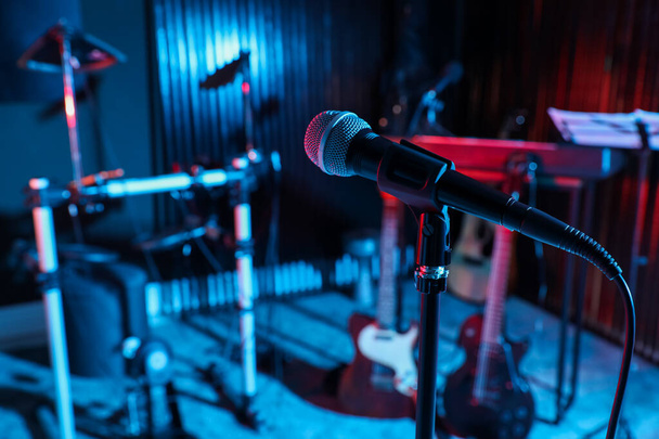 Modern microphone at recording studio, color toned. Music band practice - Φωτογραφία, εικόνα
