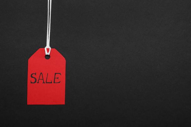 Sale red tag on color background, space for text. Black Friday - Fotoğraf, Görsel