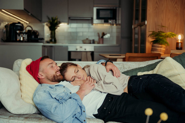 Caucasian couple lying on sofa cuddling bonding together - Foto, immagini
