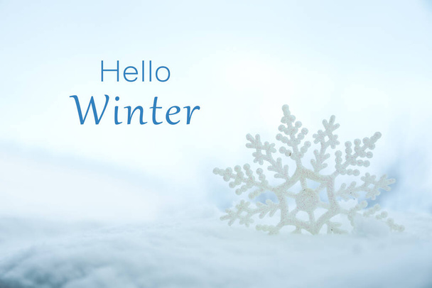 Hello Winter. Beautiful decorative snowflake in white snow - Foto, imagen