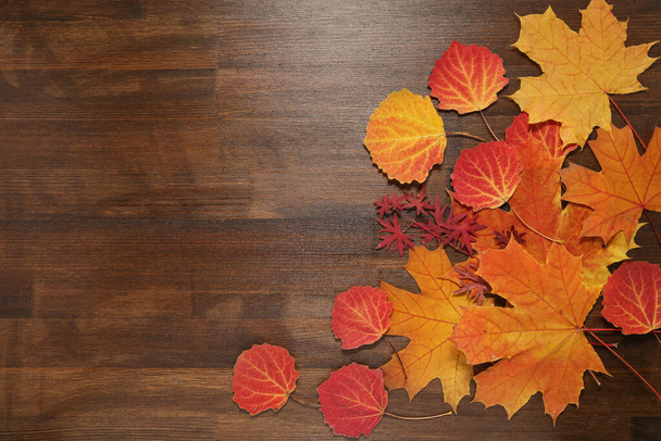 autumn leaves on wooden background - Фото, изображение