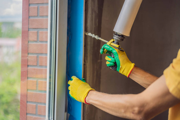 Builder or handyman is engaged in the repair or installation of windows - Fotoğraf, Görsel