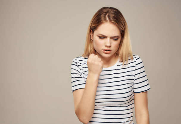 pretty woman in striped t-shirt frustration emotion displeasure - Foto, immagini