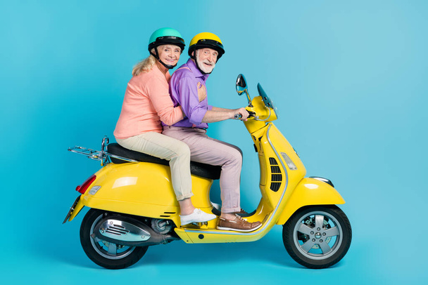 Photo of funny pretty grandmother grandfather motorcyclist wear helmets smiling isolated blue color background - Fotó, kép