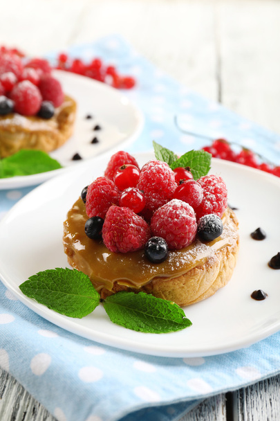 Sweet cakes with berries on table close-up - Fotoğraf, Görsel