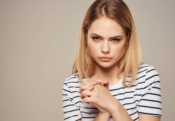 pretty woman striped t-shirt gesture hands emotions stress anger - Фото, изображение