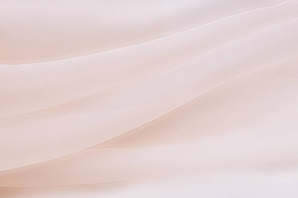 Textur, Hintergrund, Muster. Textur aus hellbeiger oder rosafarbener Seide oder Baumwolle oder Wolle. Schönes Muster aus Stoff. - Foto, Bild