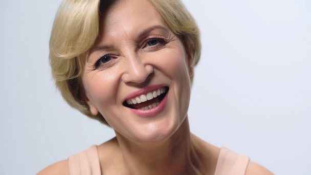 cheerful middle aged woman with perfect skin looking at camera isolated on white - Φωτογραφία, εικόνα
