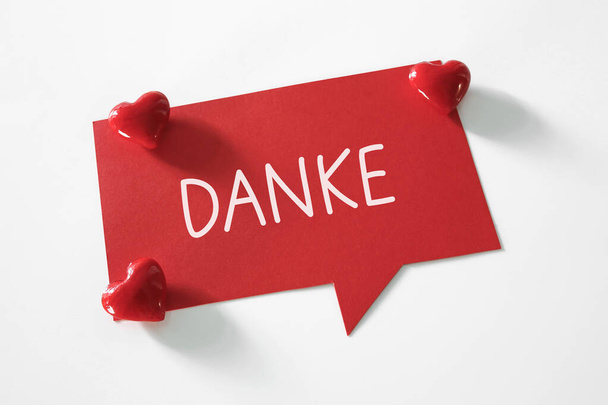 danke (thank you in german language) word written on speech bubble and red hearts - Photo, Image
