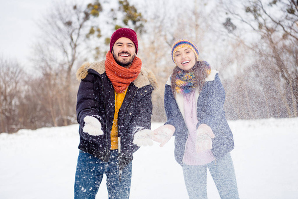 Portrait of cheerful glad man satisfied pretty lady hands throwing up snow beaming smile enjoy weekend outdoors - Photo, image
