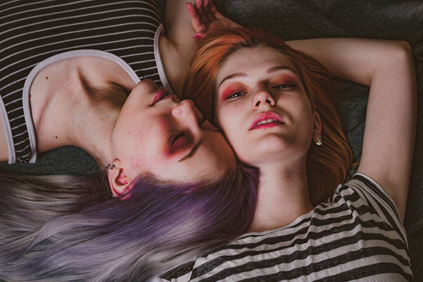 twins in striped t-shirts lie on the carpet - Photo, image