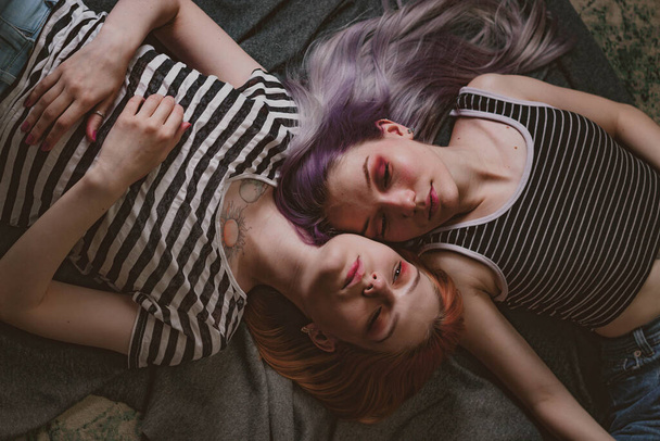 twins in striped t-shirts lie on the carpet - Φωτογραφία, εικόνα