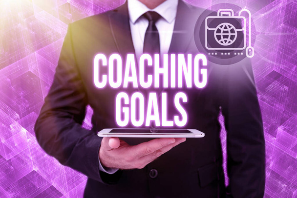 Inspiration showing sign Coaching Goals. Business idea Empowers individuals Encourages them to take responsibility Man In Office Uniform Holding Tablet Displaying New Modern Technology. - Photo, Image