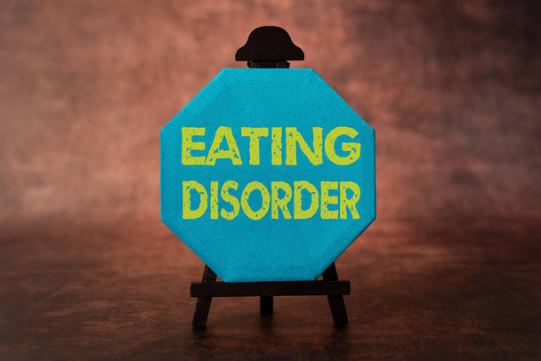 Σύμβολο κειμένου που δείχνει Διαταραχή Διατροφής. Επαγγελματικές ασθένειες βιτρίνα που χαρακτηρίζονται από ακανόνιστες διατροφικές συνήθειες Σκέψη Νέες Φωτεινές Ιδέες Αναζωογονητική δημιουργικότητα και έμπνευση - Φωτογραφία, εικόνα